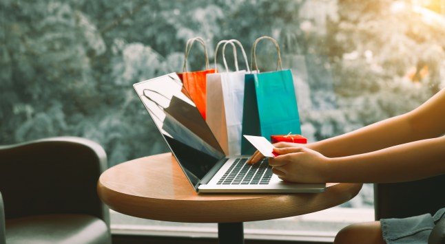 Woman using credit card with shopping online concept at cafe.