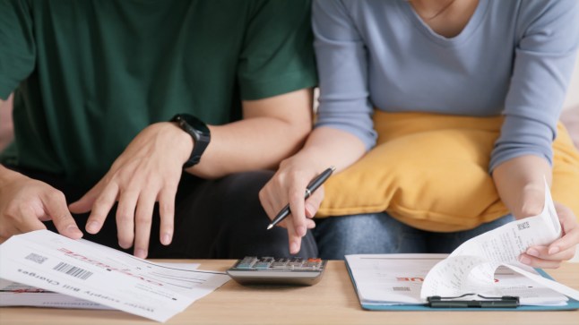 Rising high cost of living in low poor income asia people family. Past due bill debt home loan money issue young adult asian couple man woman worry shock sad tired stress in raise tax rate crisis